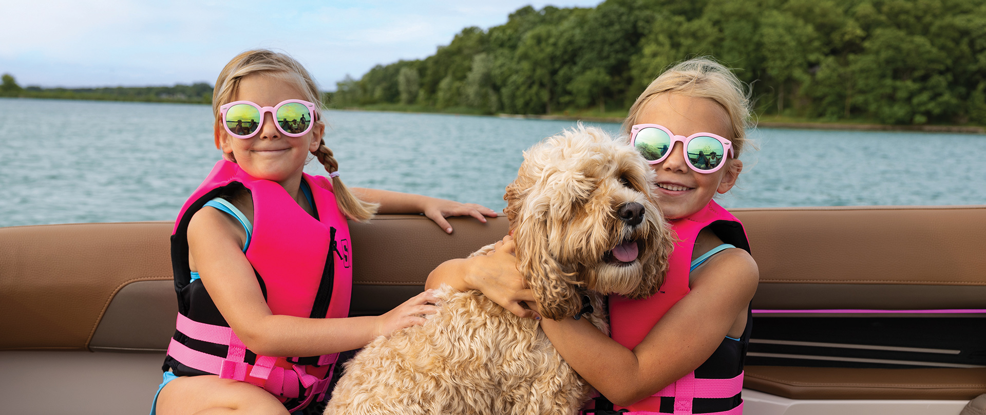 Kids on a boat with their dog